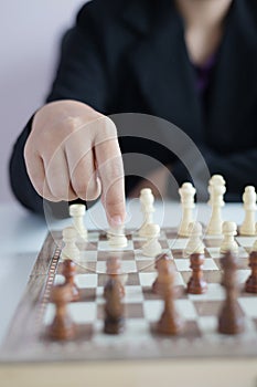 Close up shot hand of business woman playing the chess board to win by killing the king of opponent metaphor business competition