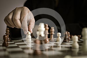 Close up shot hand of business woman playing the chess board to win by killing the king of opponent metaphor business competition
