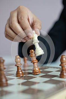 Close up shot hand of business woman playing the chess board to win by killing the king of opponent metaphor business competition