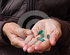 Close up shot of a hand holding several medicines