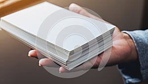 Hand Holding Stack of Blank White Paper Sheets