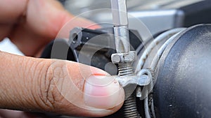 Close up shot hand of man holding a screwdriver and tighten the nut