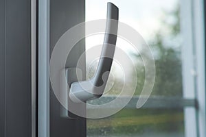 A closeup shot of the handle of a window