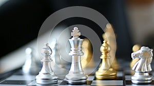 Close up shot hands of man and business woman moving gold chess and silver chess on chess board game for winner and loser busine