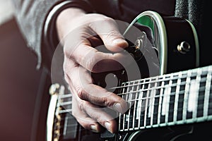 Close up shot of Hands of man playing electric guitar
