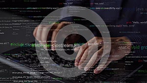 Close-Up View of Hands Typing on Laptop Keyboard with Programming Code on Screen in Dark Environment, Showcasing
