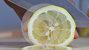 Close up shot hands of woman using kitchen knife slice cut fresh lemon