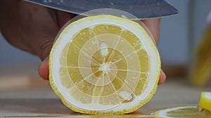 Close up shot hands of woman using kitchen knife slice cut fresh lemon