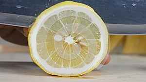 Close up shot hands of woman using kitchen knife slice cut fresh lemon