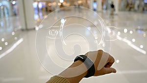 Close up shot hands of woman using smart watch with HUD user interface for cyber futuristic application and technology concep