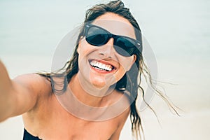 Close up shot of happy smiling female tourist. Poses for selfie