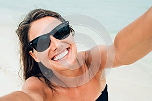 Close up shot of happy smiling female tourist. Poses for selfie