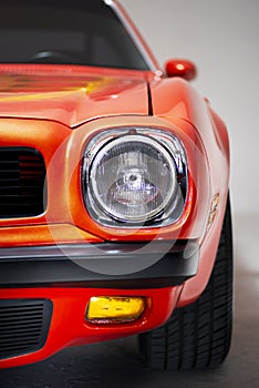 Close-up shot head light of a 1974 Pontiac Brand Trans am firebird in a studio shot