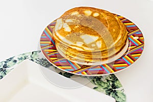 Close up shot of a home made pancakes on colorful plate. Food