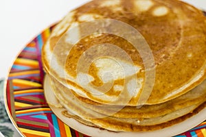 Close up shot of a home made pancakes on colorful plate. Food