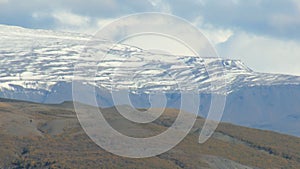 Close-up shot of huge tongue of icelandic glacier, covered by old ice and ashes