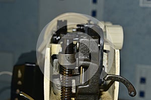 Close-up of the mechanism of movement and retention of the sewing machine needle side view
