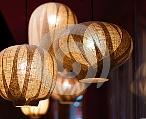 Close up shot of Japanese style fabric ceiling lamp fixture on a blurred background.