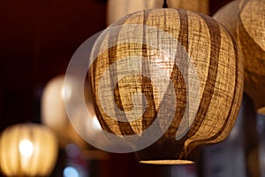 Close up shot of Japanese style fabric ceiling lamp fixture on a blurred background.