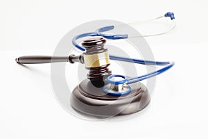 Close up shot of a judge gavel and a stethoscope