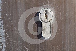 Close up shot of the keyhole on a brushed metal doorknob