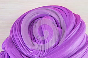 Close up shot of kids slime on light background. Purple slime.Ð¡oncept of children`s entertainment, hobbies