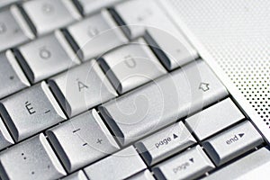 Close up shot of a laptop keyboard with the hyphen key in focus