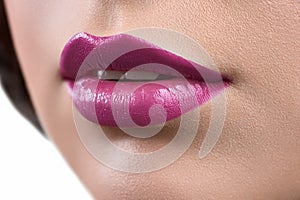 Close up shot of the lips of a woman wearing lipstick or lip glo