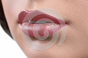 Close up shot of the lips of a woman wearing lipstick or lip glo