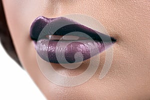 Close up shot of the lips of a woman wearing lipstick or lip glo