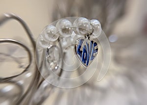 Close up shot of love pendent on pearl necklace