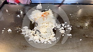 Close up shot of making egg fried rice on hot plate.