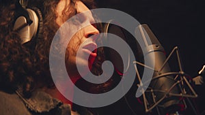 Close up shot of male singer singing into microphone