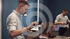 Close up shot of man getting trendy haircut at barber shop. Male hairstylist serving client, making haircut using