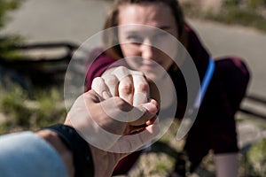 close-up shot of man giving helping hand to young woman