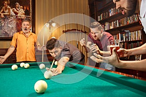 Close-up shot of a man playing billiard