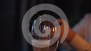 Close up shot of a man that pours champagne into a glasses. Valentines day. making a marriage proposal.