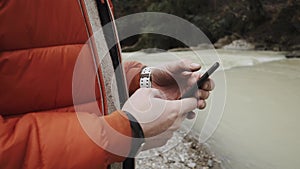 Close up shot of the man`s hands, he prints text messages on the new smartphone