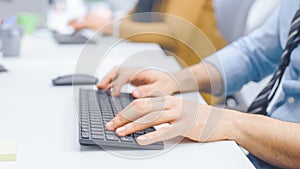 Close-up Shot of Man typing on a Keyboard, Using Mouse. Businessman / Office Clerk Working on Desk
