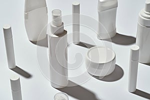 Close up shot of many different white tubes and bottles for hygiene, health and beauty isolated over white background