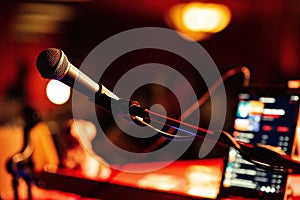 Close-up shot of a microphone in a blurry bar setting.