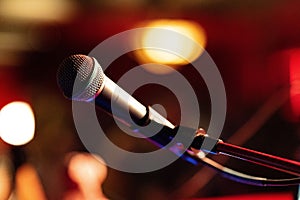 Close-up shot of a microphone in a blurry bar setting.