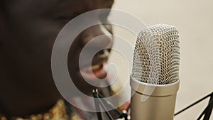 Close up shot of microphone and man`s face. Close up shot of singer.