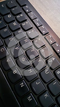 A close-up shot of a modern, black computer keyboard