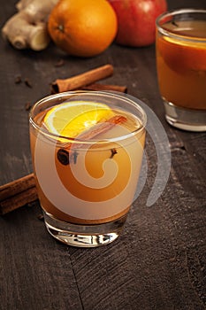 Mulled Wassail Cider with cinnamon sticks with fruit and ginger close up shot