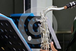 Close-up shot of a musician man playing a saxophone outdoor, selectable focus