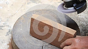 Close up shot  of old worker hands carpenter equals polishes wooden board with a random orbit sander in the workshop, sanding vint