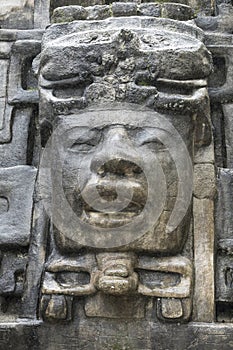 Close up shot of the Olmec stone mask on the Mayan temple of Lamanai in Belize