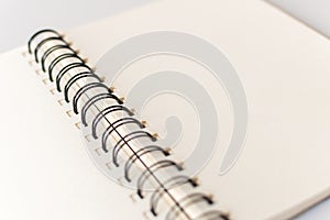 Close up shot of an open blank sketchbook placed on a light gray table. photo