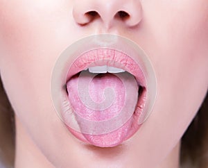 Close up shot of an open mouth and a healthy human tongue